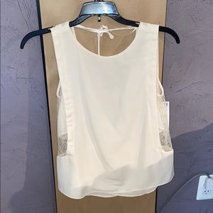 Never worn, cream top with lace sides.